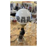 Collection of Glass Bottles, Animal-Themed Lamp, and Decorative Glassware