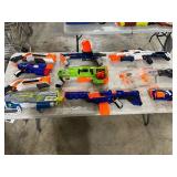 TABLE FULL OF NERF GUNS
