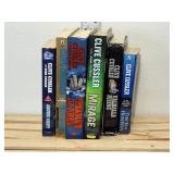6 Clive Cussler books, 3 soft cover books, 3 hardcover our treasure of KHAN, mirage, Valhalla rising, soft cover, Arctic drift, blue gold, the sea hunters