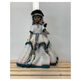 14 inch doll hand crocheted dress with bead and silver toe embellishments tall is made in China one081. Comes with doll stand.