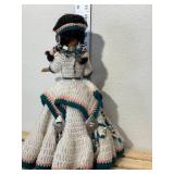 14 inch doll hand crocheted dress with bead and silver toe embellishments tall is made in China one081. Comes with doll stand.