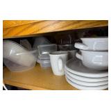 Assorted Collection of Kitchenware including Plates, Bowls, and Plastic Containers