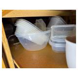 Assorted Collection of Kitchenware including Plates, Bowls, and Plastic Containers
