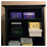Black Tall Bookcase with Storage and Assorted Colored Boxes