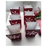 Collection of Holiday Decor: Red Themed Candle Holders, Nested Gift Boxes, and Wall Ornament
