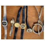 Vintage watch collection with assorted bands and accessories