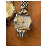 Vintage watch collection with assorted bands and accessories