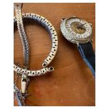 Vintage watch collection with assorted bands and accessories