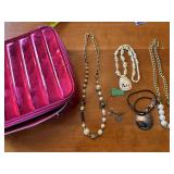 Collection of Costume Jewelry Necklaces and Bracelets with Metallic Pink Bag