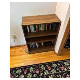 Wooden Bookshelf with Assorted Books Collection
