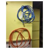 Set of Household Brooms, Extension Cords, and Metal Trash Can