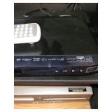 Cabinet with LG Blu-ray Player and Sylvania DVD Player with Remote Controls