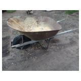 Used Metal Wheelbarrow with Single Wheel and Wooden Handles