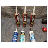 Collection of Caulking Guns and Sealant Tubes