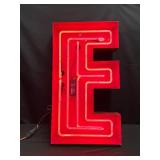 Ruby Red neon "E" with red metal outline, red channel letter, neon sign letter