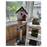 Collection of Rustic Garden Decor Including Birdhouses, Wind Chimes, and Signs