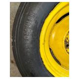 One Yellow Rimmed John Deere Front Tractor Tire and Second John Deere Tire