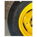 One Yellow Rimmed John Deere Front Tractor Tire and Second John Deere Tire