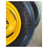 One Yellow Rimmed John Deere Front Tractor Tire and Second John Deere Tire