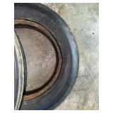 One Yellow Rimmed John Deere Front Tractor Tire and Second John Deere Tire