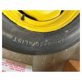 One Yellow Rimmed John Deere Front Tractor Tire and Second John Deere Tire