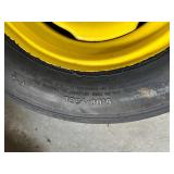 One Yellow Rimmed John Deere Front Tractor Tire and Second John Deere Tire