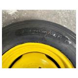 One Yellow Rimmed John Deere Front Tractor Tire and Second John Deere Tire