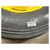 One Yellow Rimmed John Deere Front Tractor Tire and Second John Deere Tire