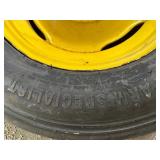 One Yellow Rimmed John Deere Front Tractor Tire and Second John Deere Tire