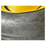 One Yellow Rimmed John Deere Front Tractor Tire and Second John Deere Tire