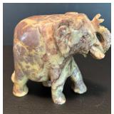 Two Decorative Stone Figurines: Egyptian Sphinx and Elephant