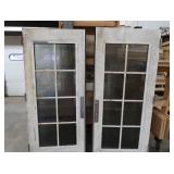 A SET OF TWO HEAVY DUTY STEEL AND GLASS METAL SAFETY DOORS