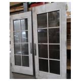 A SET OF TWO HEAVY DUTY STEEL AND GLASS METAL SAFETY DOORS