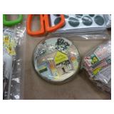 Can full of whatever fits - clock, scissors, stamps, watch, microfiber cloth, plate stands, vacuum bags