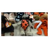 Sand pail full of beanie babies and dinosaur temporary tatoos