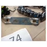 5 belt buckles, truckers wallet with chain, knife sheath, lighter, grain belt opener