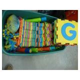 large tote full of foam interlocking blocks and other foam toys
