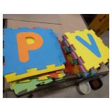 large tote full of foam interlocking blocks and other foam toys