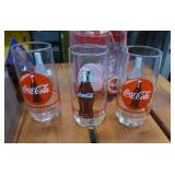 8 Coca-Cola glasses and a Talking Mug