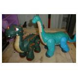 Two dinosaurs - dark green is battery operated