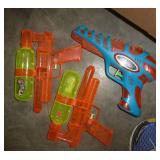 Lot of balls, frisbees, squirt guns, sand box tools