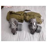 2 Vintage Finnish military gas masks, Suod 61T KRH ASC 12x30, with green canvas carrying bag.