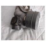 2 Vintage Finnish military gas masks, Suod 61T KRH ASC 12x30, with green canvas carrying bag.