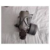2 Vintage Finnish military gas masks, Suod 61T KRH ASC 12x30, with green canvas carrying bag.