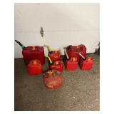 11 empty gas cans of various sizes