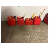 11 empty gas cans of various sizes