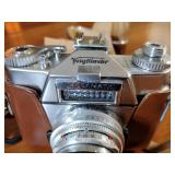 Canon AE-1 camera; Minolta Freedom GT; Hawkey Instamatic; Voigtlander Bessamatic 35mm SLR.