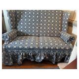 Blue country print wingback settee (loveseat) with ruffled skirt.  L 57” x H 40” x W 29” Bring help to move.