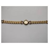 Oleg Cassini 32-420 quartz watch. Quartz watch with plain band and rhinestones on the dial face.