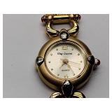 Oleg Cassini 32-420 quartz watch. Quartz watch with plain band and rhinestones on the dial face.